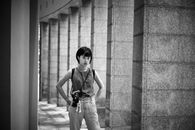Grayscale Photo of a Woman with Camera