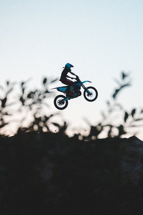 A Man Riding a Motorcycle on Mid Air