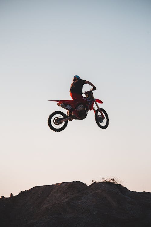 Man Riding a Dirt Bike Jumping on ta Ramp