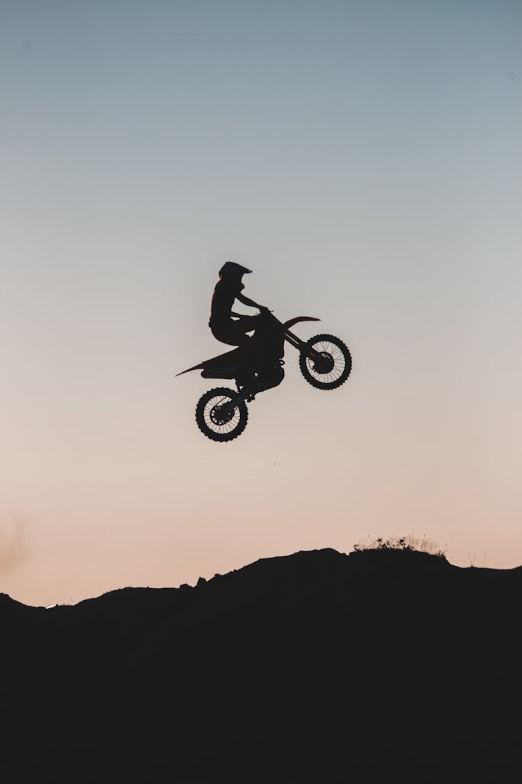 Man Riding A Dirt Bike Jumping On A Ramp