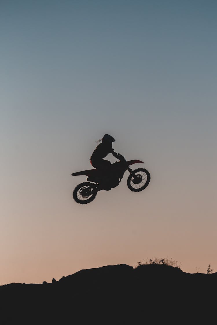 A Person Doing A Stunt On A Motorbike