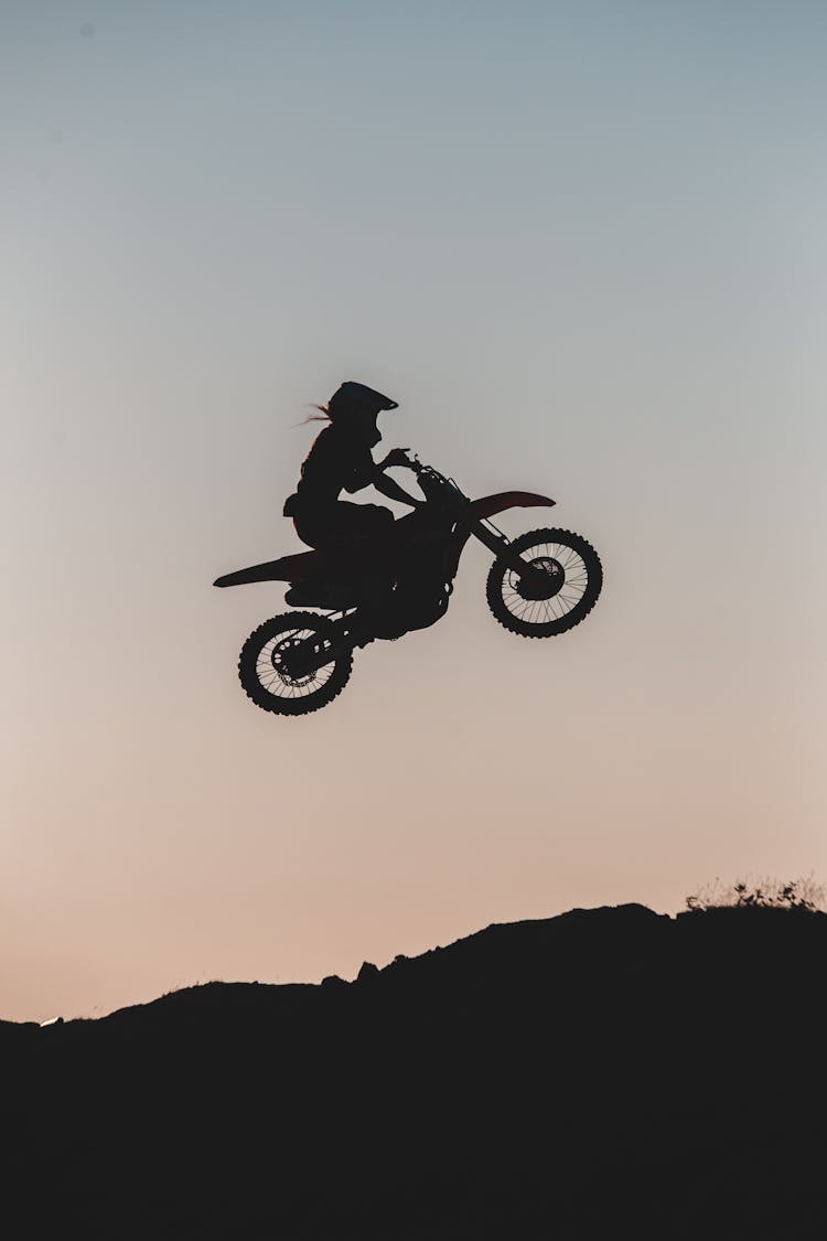 Silhouette Of A Man On Dirt Bike In Mid Air