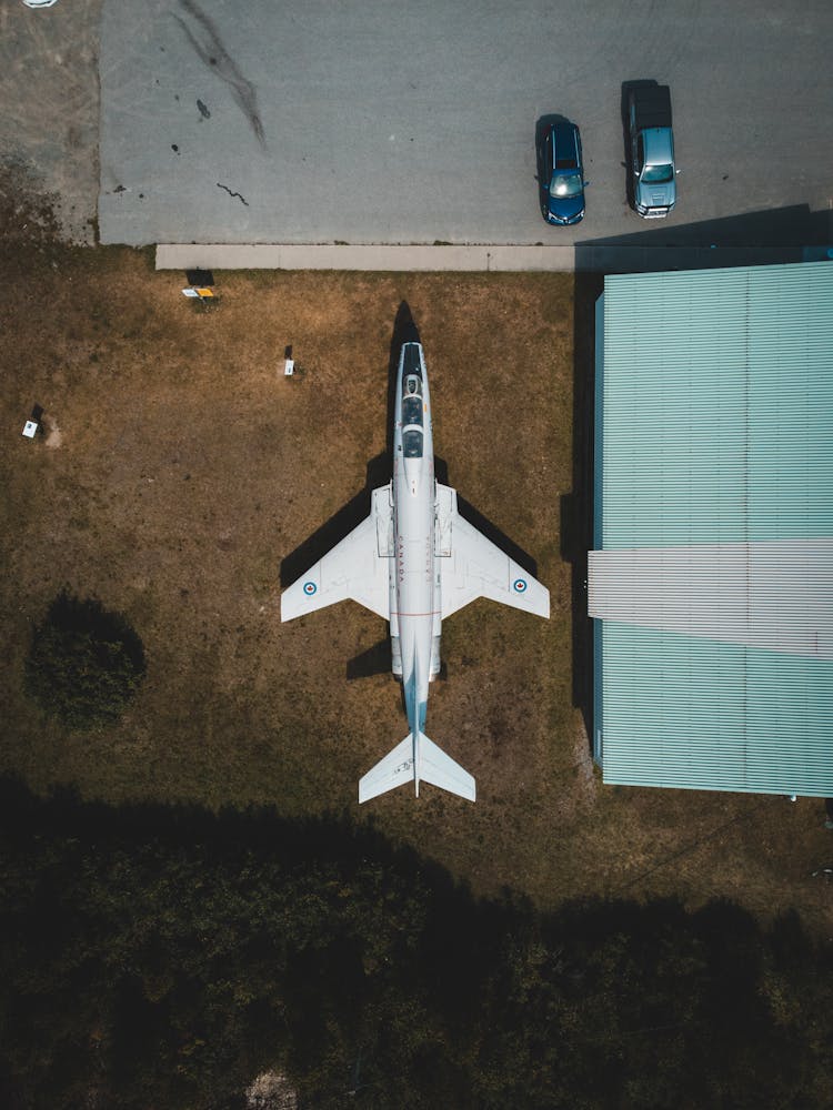 Aerial Shot Of White Airplane Parked On Ground