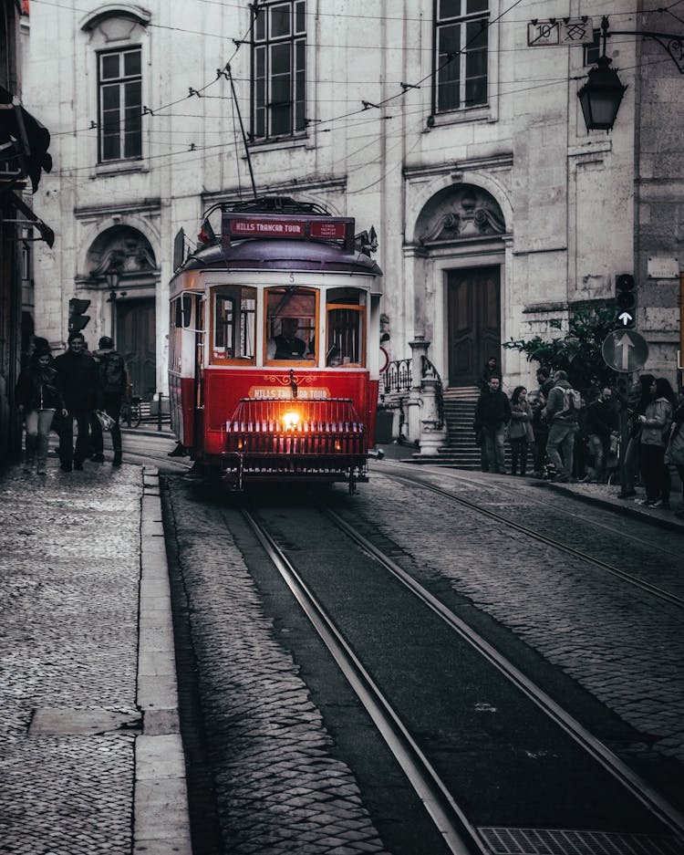 A Red And White Tram On Tramway Track