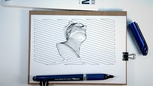 A Sketch on a Man in Low Angle Shot on a Paper