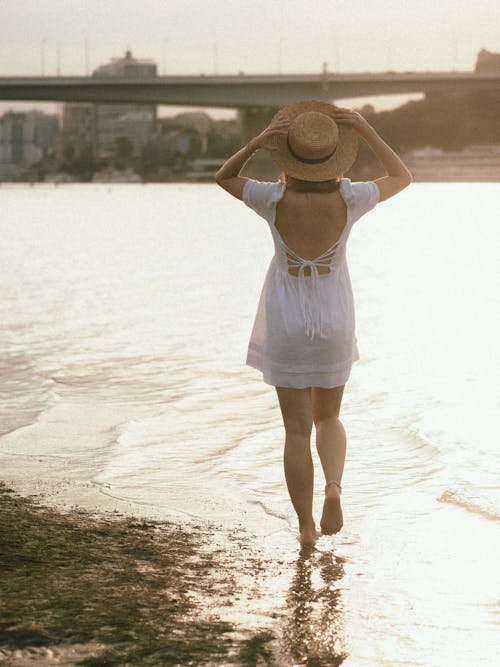 Back View of a Woman in White Dress