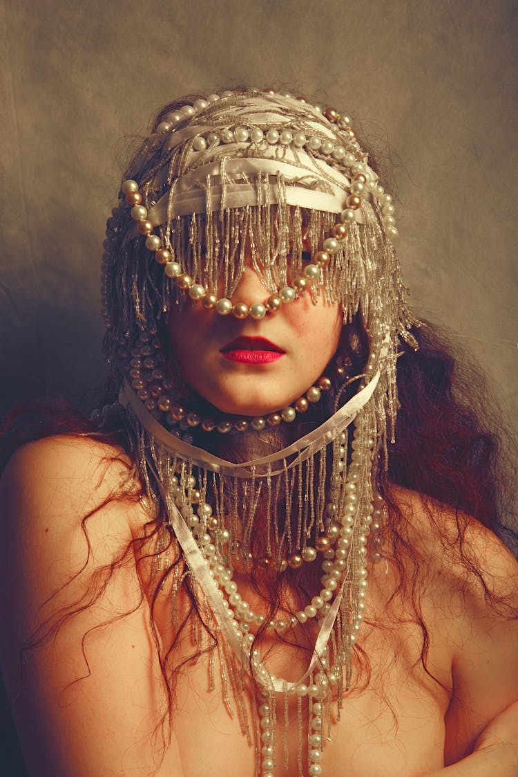 Woman With Face Covered By Headdress