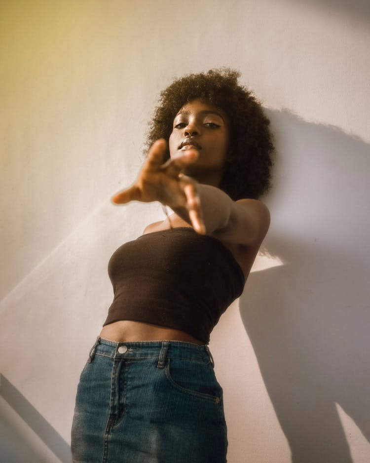 Woman In Black Tube Top With Head Leaning On Wall