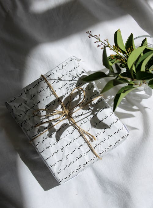 Gift Box with Brown Ribbon on White Textile