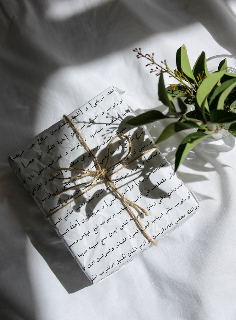 Gift Box With Brown Ribbon On White Textile