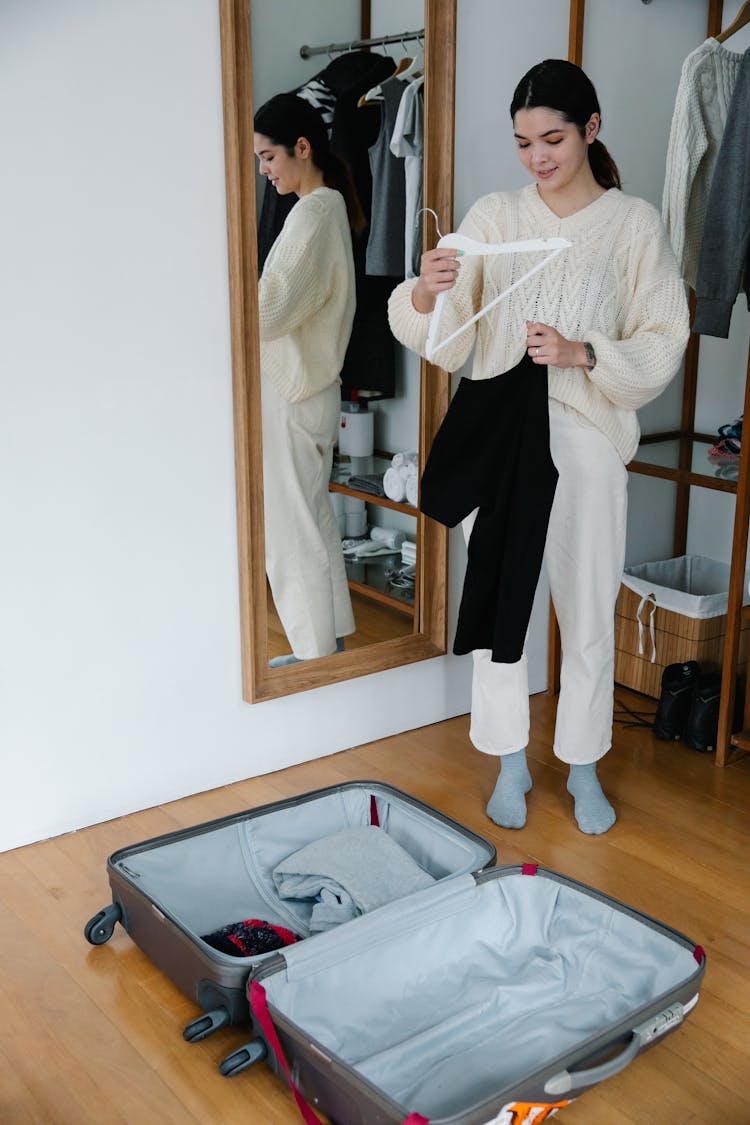 Woman Holding White Hanger With Black Shirt