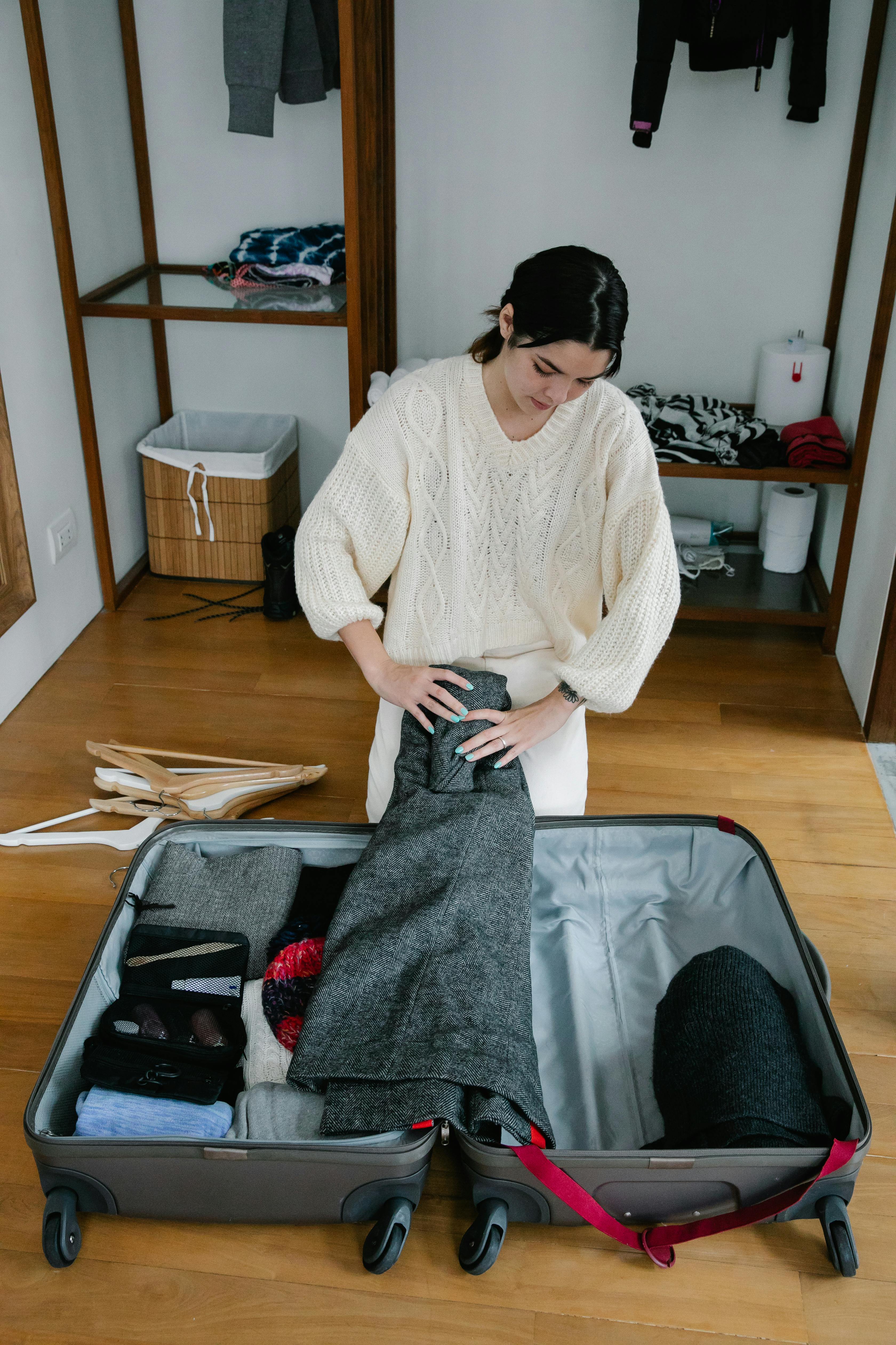 A Woman Packing Her Suitcase · Free Stock Photo