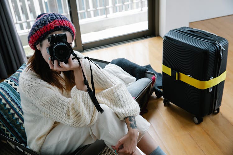 Woman With Black And Red Headwear Holding Black Camera