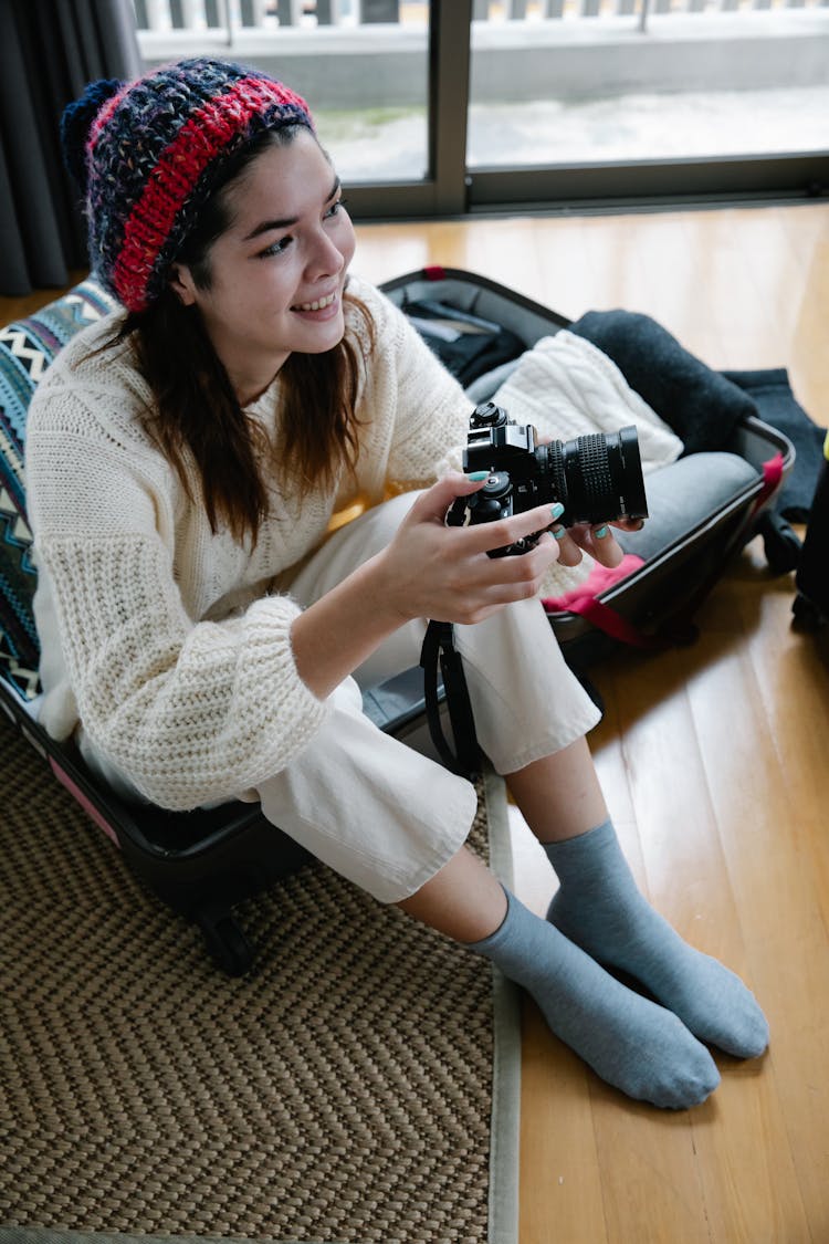 Woman In White Knitwear Holding Black Camera