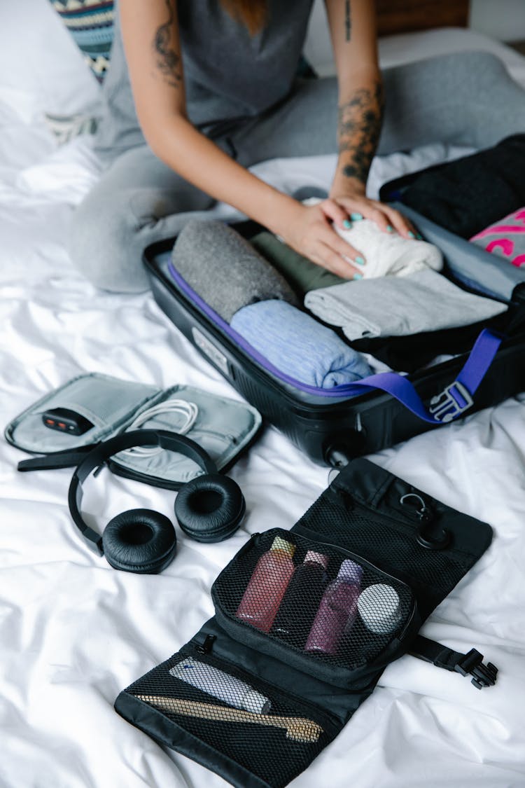 Black Headphones Beside Bag With Toiletries