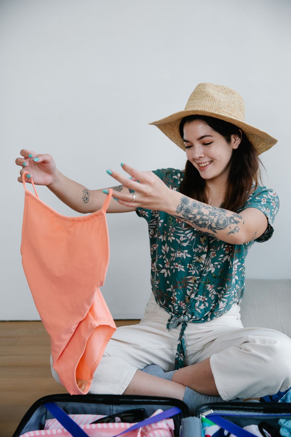 Woman preparing a suitcase with neatly arranged clothing
