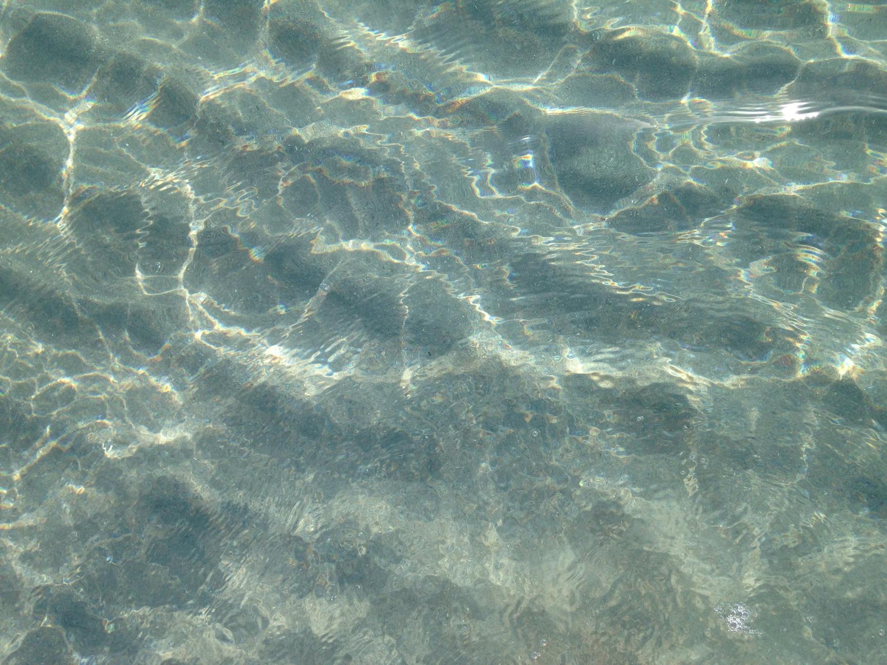 Crystal clear ocean water displaying peaceful ripples and reflections in Boca Raton, Florida.