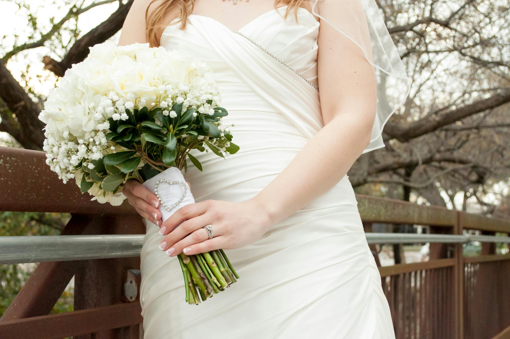 Woman Wearing White Wedding Gown While Holding Flowers · Free Stock Photo