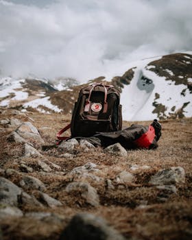 Backpack set against a stunning snowy mountain backdrop, perfect for hiking enthusiasts.