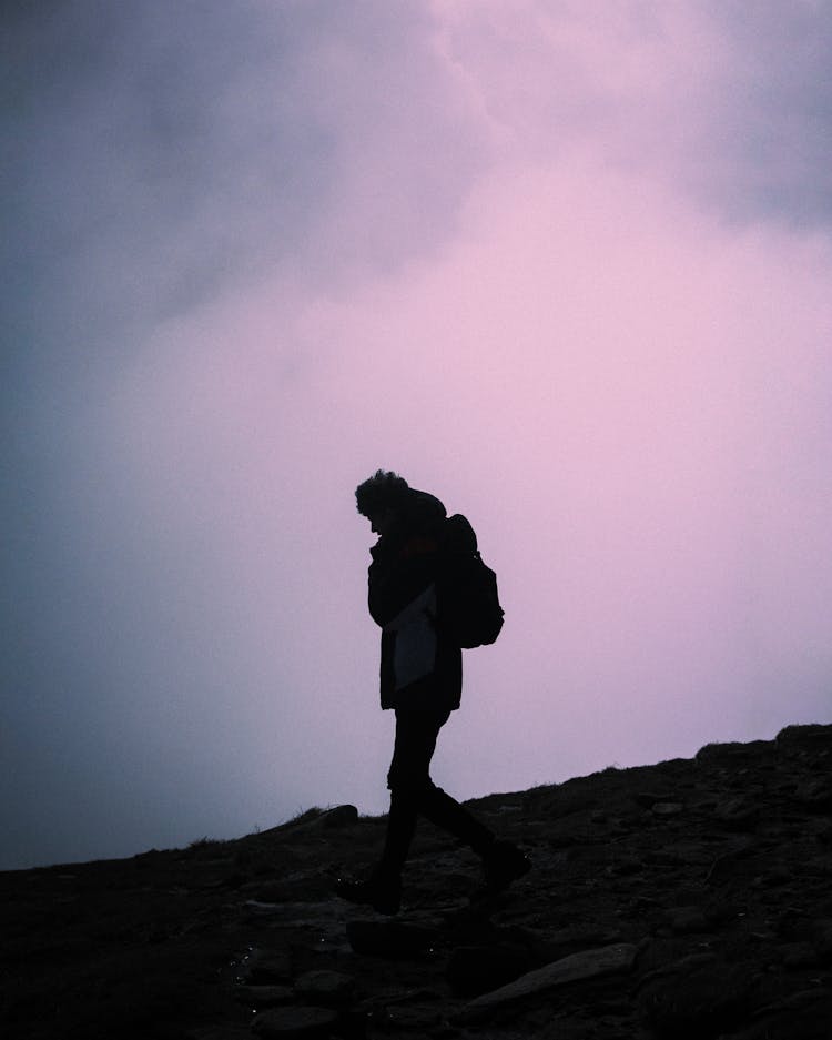 A Backpacker Walking Downhill