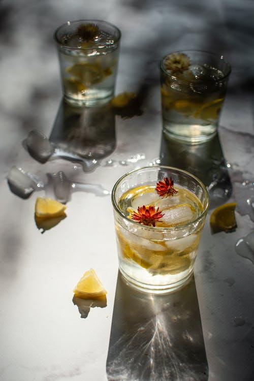 A Drink with Lemon Slices and Flowers