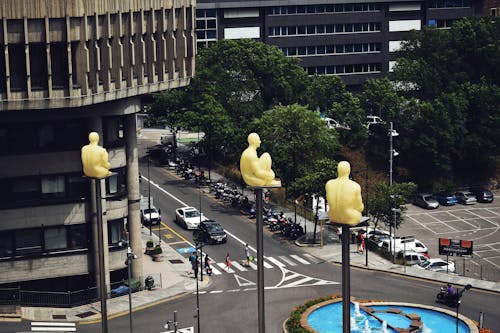 Birds Eye View Photo of Sitting Statues on Outdoor Post