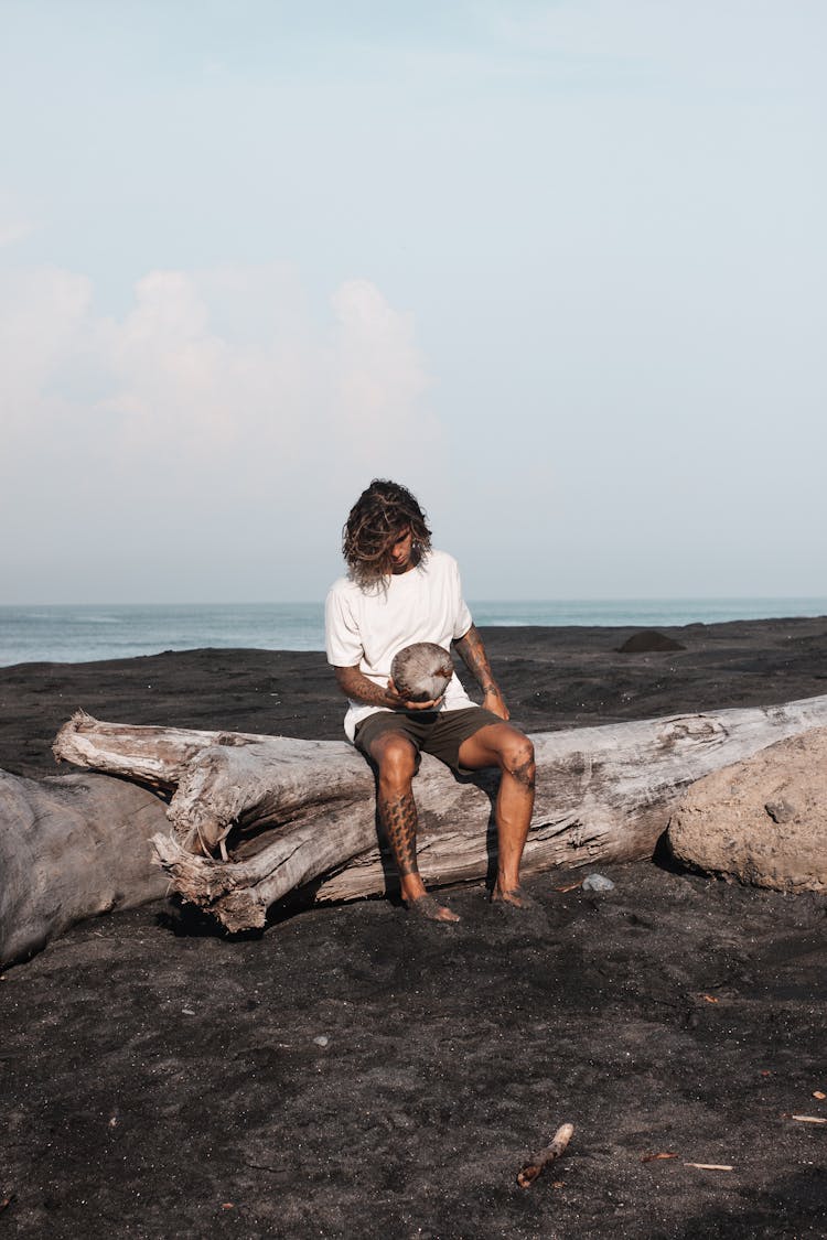 Man Sitting On Beach