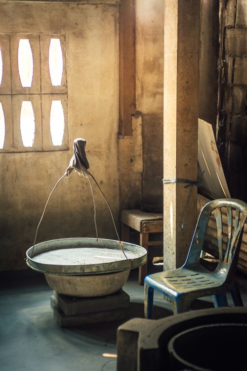 Free A rustic room featuring a vintage wash basin and plastic chair in soft natural light. Stock Photo