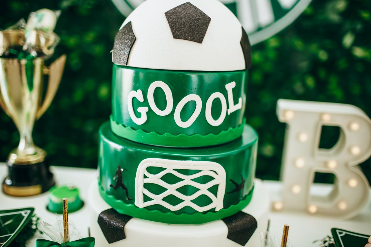 celebrate in style with a soccer themed cake featuring a trophy and de