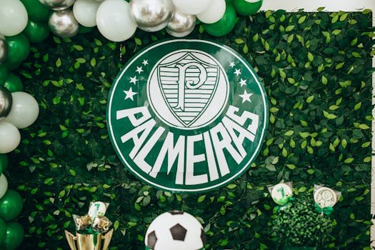 Green and white Palmeiras themed backdrop with balloons and football decorations.