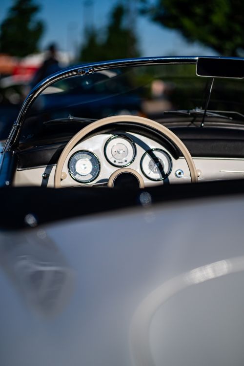 Free Close-up of a vintage car's dashboard and steering wheel in sunlight. Stock Photo