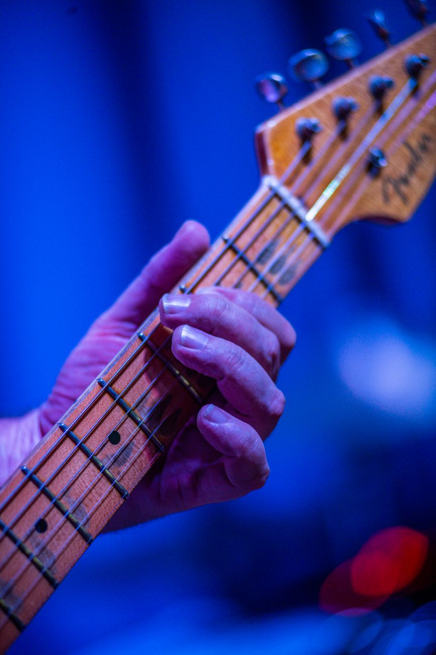 Intense close-up of a musician's hand playing an electric guitar on stage.. intense, close, musicians