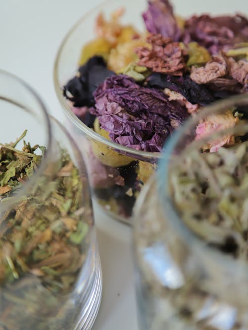 Free A Close-Up Shot of Dried Flowers and Leaves in Glass Containers Stock Photo