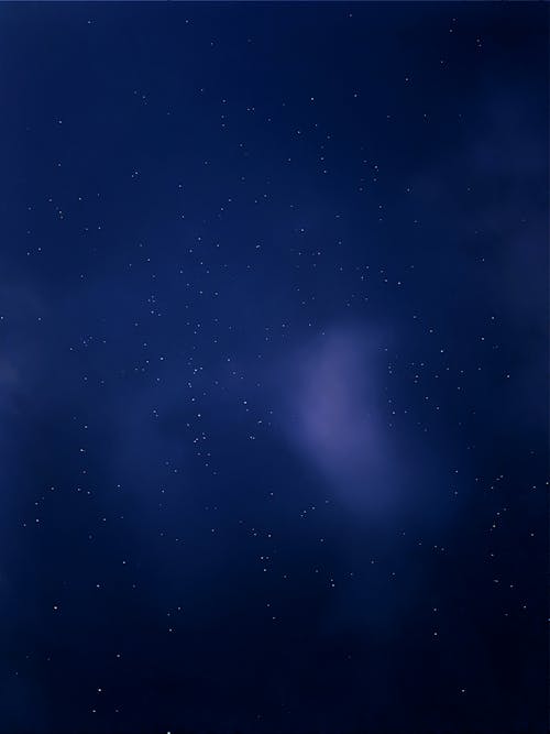 A Blue Starry Sky Behind a Thin Cloud