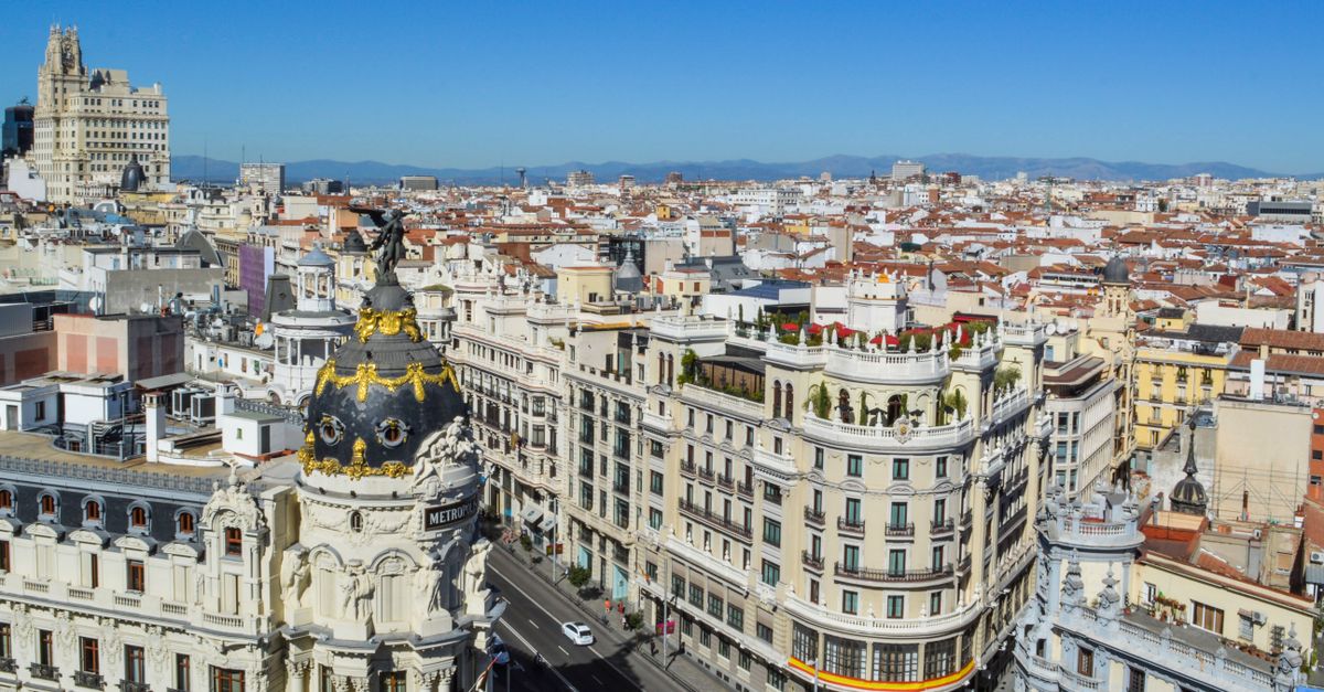 Stunning aerial view of Madrid's Gran Via showcasing historic architecture under clear blue skies.