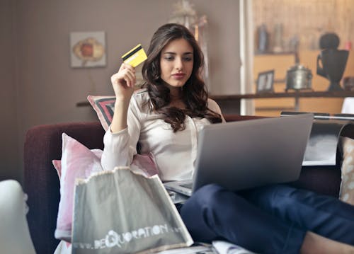 A woman shopping online on her computer. Large print books for visually impaired can be purchased online on a number of websites.