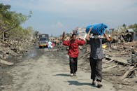 People walking on Dirt Road after an Environmental Disaster