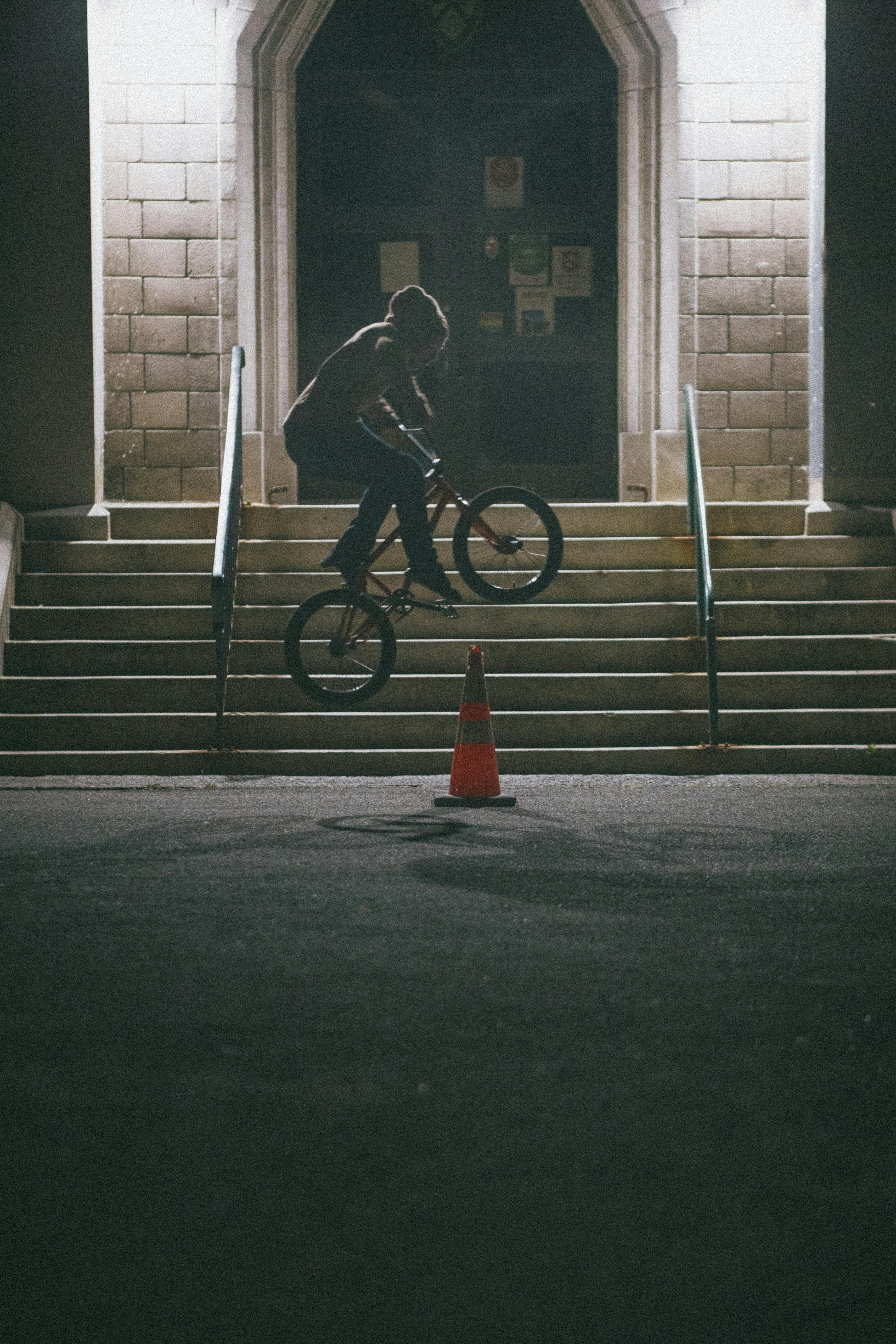 A Person Doing A Stunt With A Bike At Night · Free Stock Photo