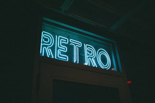 A White Retro Neon Sign on Top of a Door