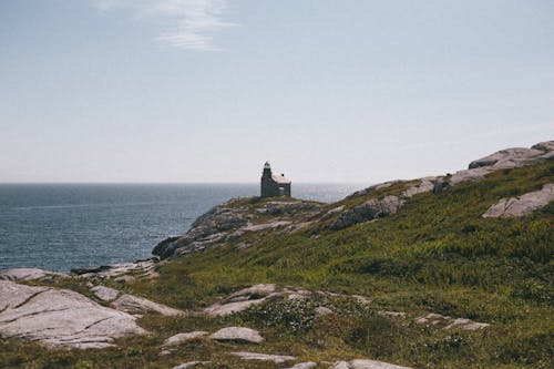 Lighthouse on the Rocky Coast and Sea