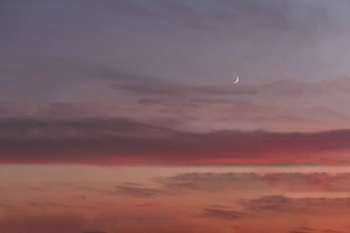 A Crescent Moon on  Gray Sky 