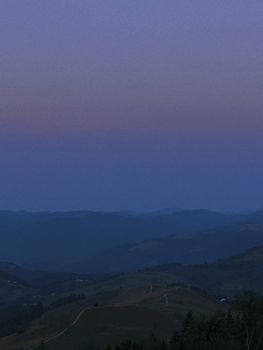 Serene twilight view of rolling hills in Ukraine, capturing the peaceful beauty of dusk.