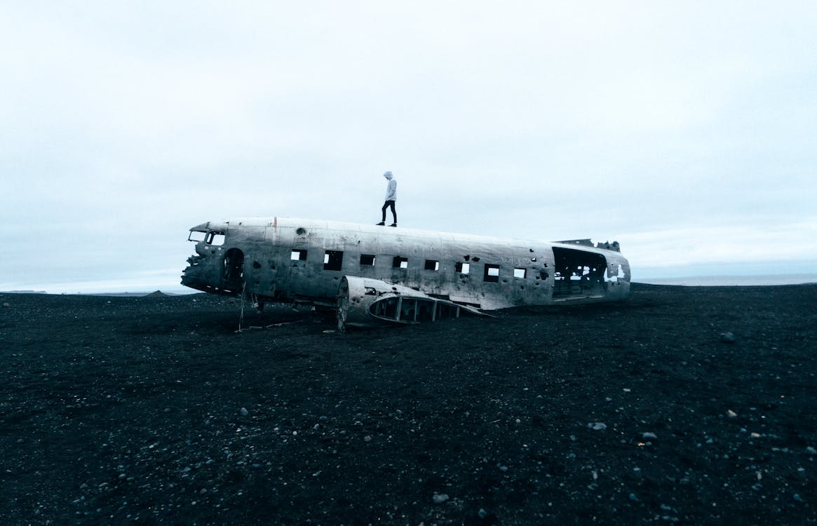 Free Person Standing on Wrecked Plane Stock Photo