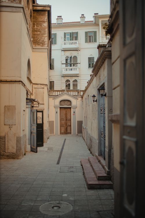 Free Discover a quaint narrow alley in a historic old town, showcasing classic architectural beauty. Stock Photo