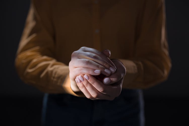 A Person's Hands Holding A Ball