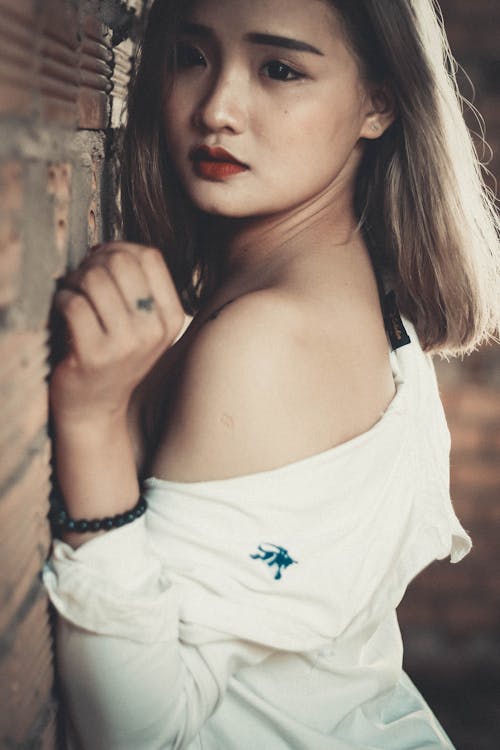 Shallow Focus Photography of Woman in White Off-shoulder Top