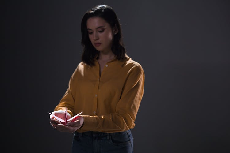 Woman Holding An Origami Bird