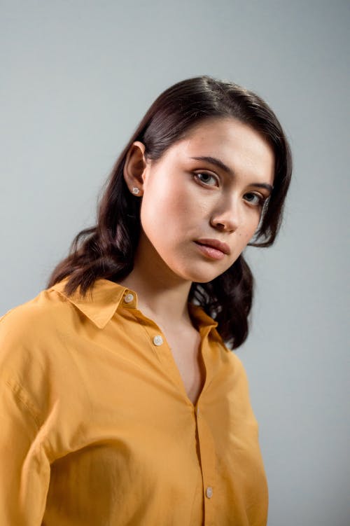 Free Portrait of a Woman in Yellow Button-Up Shirt Looking at the Camera Stock Photo