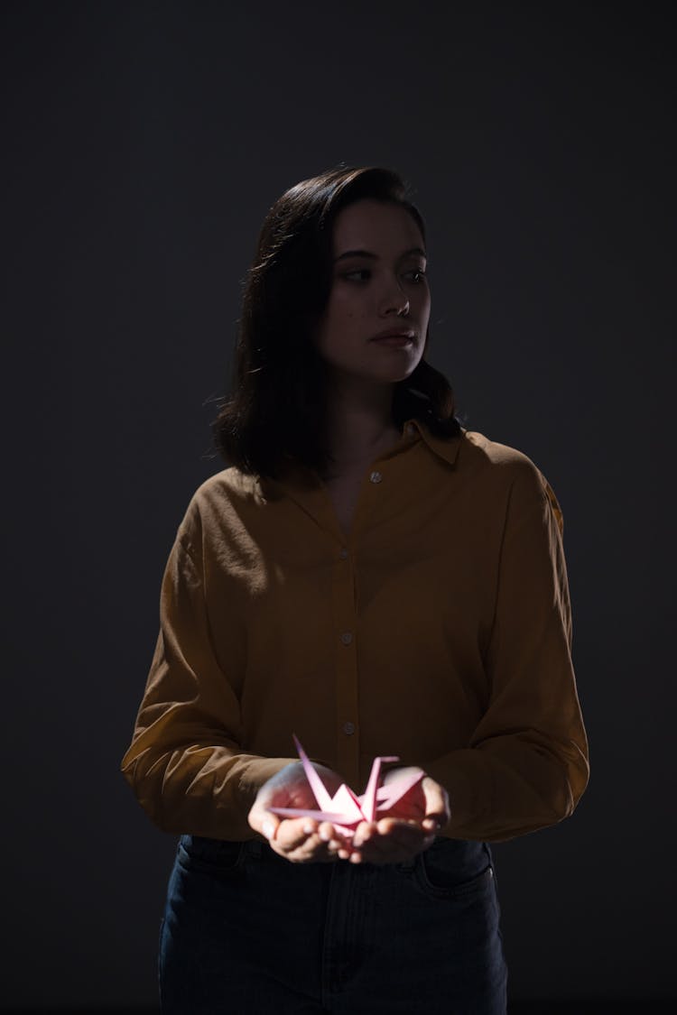 Woman Holding An Origami Bird