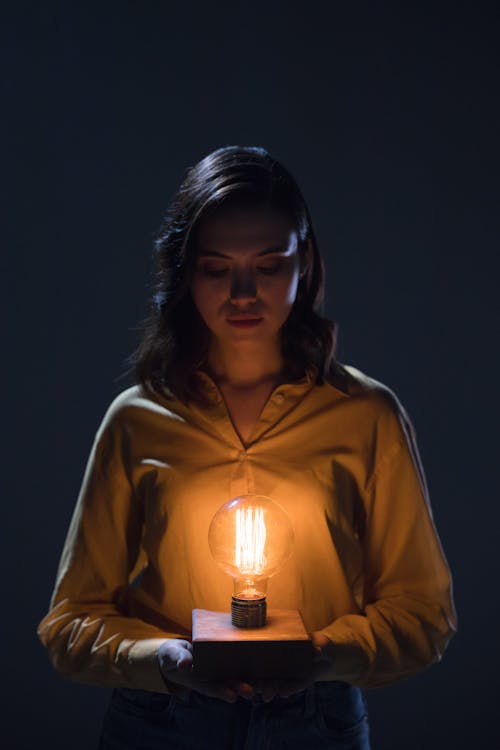 A Woman Holding a Light Bulb